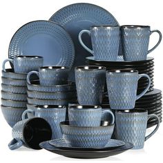 the blue dishes and cups are stacked together