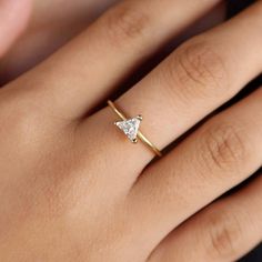 Elevate your everyday look with our 18k Gold Filled Trillion CZ Solitaire Ring. This delicate and gorgeous ring sparkles with a stunning trillion cut CZ stone, adding a touch of elegance to any outfit. The perfect blend of simplicity and luxury, it's a must-have for any stylish fashionista! DETAILS: * 18k gold-filled, Water resistant, CZ Stone MEASUREMENTS: * Size: 5 mm stone CARING TIPS: * Avoid contact with sweat, lotions & perfumes as these can tarnish the jewelry * Keep jewelry clean and dry  * We recommend using polishing cloths to restore the shine to your jewelry OTHER INFORMATION: * All items are packaged in elegant jewelry pouches * Have any questions? Feel free to contact us. We reply fast! MORE FROM US  https://leycorjewelry.etsy.com Instagram: @leycorjewelry 14k Gold Trillion Cut Diamond Promise Ring, Trillion Cut Diamond Ring With Prong Setting As Gift, Trillion Cut Diamond Promise Ring In 14k Gold, Trillion Cut Moissanite Rings For Gift, Minimalist Trillion Cut Rings For Anniversary, Trillion Cut Diamond Ring For Wedding, Minimalist Trillion Cut Anniversary Rings, Trillion Cut Single Diamond Promise Ring, Gold Trillion Cut Diamond Ring As Gift