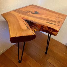 a wooden table with hairpin legs and a wood slab on the top that has been turned into a desk