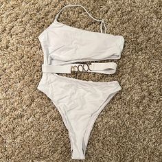 White Swimsuit With Gold Accents. Never Worn Trendy White One-piece Swimwear, Trendy White Lined Swimwear, White Beachwear Bodysuit For Summer, White Lined Swimwear For Spring, White Summer Bodysuit For Beach, White Summer Party Swimwear, White Summer Bodysuit For Beach Season, White Stretch Bodysuit For Beach Season, Trendy White Sleeveless Swimwear