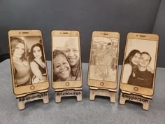 three wooden cell phones with pictures on them