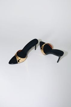 Our best selling Gia Mules reimagined in a 80 mm heel. Gia is a minimal mule that will garner all the attention. Mirrored Gold Upper Strap & Glossy Black Vegan Patent Leather insole. Size and Fit Information: U.S. Sizing Available in whole and half sizes Runs true to size (Note: Not using leather and other materials from animals significantly reduces environmental impact, however, we acknowledge that synthetic alternatives are not without environmental concerns. As we grow, we are dedicated to f Environmental Concerns, Us Man, Slingback Pump, Gold Mirror, Environmental Impact, Black Patent Leather, Mule, Gold Black, Patent Leather