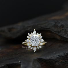 a close up of a diamond ring on a piece of wood