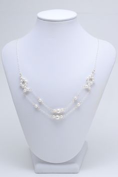 "Be transported back to a time of pure style and elegance! This 1920s-esque necklace consists of twin Swarovski pearls arranged in a diamond shape, draped with dual chains intertwined with more pearls, strung along a gossamer sterling silver chain. The back connects with a sterling silver infinity hook clasp flanked by accent pearls. The pearls measure 6mm & 4mm and are white in color, except for the four pearls surrounding the center bigger pearls, as those are light creamrose in color for mino Wedding Multi-strand Pearl Drop Necklaces, White Multi-strand Pearl Necklace For Formal Occasions, Elegant Silver Multi-strand Pearl Necklace, Vintage Multi-strand Pearl Necklace For Formal Occasions, Swarovski Pearl Necklace, Vintage Multi-strand White Pearl Necklace, Geode Necklace, Crown Necklace, Snowflake Necklace