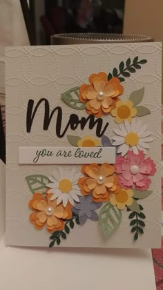 a mother's day card with flowers on it