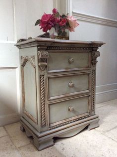 an old dresser with flowers on top of it