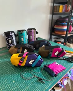 many different colored bags are sitting on a table