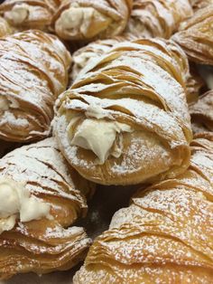 croissants covered in powdered sugar and cream