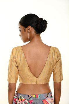 Introducing the Gold Brocade Blouse with Deep V Neckline—a timeless piece that exudes sophistication and style. Crafted from luxurious brocade fabric, this blouse features a striking deep V neckline and elegant elbow-length sleeves, creating a chic and refined silhouette. Perfect for formal occasions or festive events, this blouse adds a touch of opulence to any ensemble. Pair it with a saree or lehenga for a look that radiates elegance and class. Gold Brocade Blouse, Latest Blouse Designs Pattern, Brocade Blouse, Cotton Gowns, Ruffle Saree, Brocade Blouses, Indo Western Dress, Net Lehenga, Gold Brocade