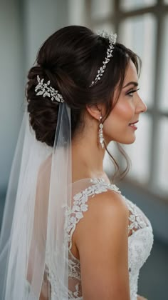 a woman in a wedding dress with a veil on her head