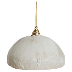 a white and gold pendant light hanging from a ceiling