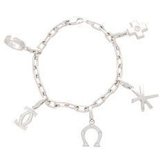 A beautiful vintage Cartier charm bracelet set in 18k white gold. The piece is firstly composed of an elegant link bracelet, fastened with a secure lobster clasp with the Cartier logo stamped to one side. From this link bracelet hangs five beautifully crafted solid gold charms; a love ring, a diamond set double C motif, a diamond horseshoe, a star, and a diamond set cross. Each charm is attached to the bracelet with a secure lobster clasp, meaning that there is versatility to move the charms to the desired positioning. Alternatively, these charms could be removed and worn as a pendant around the neck on a simple chain. Due to the size and design, the bracelet would be a perfect piece for everyday wear. The size of the links within the chain bracelet allows the wearer to add additional char Cartier Logo, Cartier Diamond, Solid Gold Charms, Gold For Sale, Bracelet Box, Gold Charms, Fitness Bracelet, Diamond Charm, Diamond Set