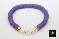 Purple and Gold Bracelet in Heishi Beads by Regina Harp Designs These bracelets are in a purple, white and gold colors with your choice of bracelet style. They can be made with our other bead colors as well; message us if you would like to customize your bracelet. If you need a smaller or extra large size in the bracelet, please leave us a note with your order. To measure your wrist size you can wrap a piece of string around your wrist and mark it. Then lay the string down and see how long it is Personalized Purple Round Beads Stretch Bracelet, Personalized Purple Stretch Bracelet With Round Beads, Purple Stretch Bracelet With Letter Beads, Adjustable Purple Heishi Beads Bracelets, Purple Heishi Beaded Bracelets With Letter Beads, Purple Heishi Beads Round Bracelets, Adjustable Lavender Beaded Bracelets With Letter Beads, Purple Heishi Beaded Bracelets, Purple Heishi Beads Bracelet With Letter Beads