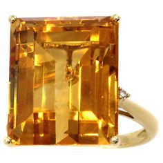 Cut into a perfect emerald cut, this Golden Citrine is the center-piece of this well handcrafted 18 karat yellow gold 1980s ring. The well saturated gemstone, which measures to weigh approximately 10 carats is full of life and fire. This chic and stylish ring has 2 bright white round brilliant cut diamonds embellishing the top of the shanks, giving the ring the perfect finishing touch. Ring size 7.5 and can be sized. Sapphire Cocktail Ring, Chic Rings, Fancy Jewellery Designs, Citrine Jewelry, Mabe Pearl, Gold Cocktail Ring, Diamond Jewelry Designs, Gold Cocktail, Dope Jewelry