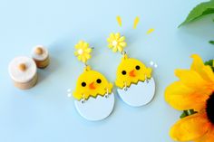 "♥ Hatching Chick Earrings ♥ This pretty pair of earrings is perfect for cool chicks, chicken owners, birds and animal lovers and earring ethusiasts! Some key features: ♥ Laser cut with bright, uplifting yellow acrylic with a pretty yellow flower. ♥ bottom half swings playfully and you will fall in love with the cute chick's chirp! ♥ Designed, crafted and packaged in Sehreen's Art Lab ♥ Size of the earrings: 2.5\" ♥ Materials: Acrylic See more cute pins and earrings at my shop here! etsy.com/sho Playful Yellow Dangle Earrings, Whimsical Earrings For Spring Gift, Whimsical Spring Earrings For Gift, Blue Quirky Earrings As Gift, Quirky Blue Earrings For Gift, Playful Earrings With Cute Design As Gift, Playful Earrings For Spring Gift, Playful Yellow Hypoallergenic Earrings, Easter Jewelry Gift For Pierced Ears