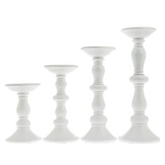 four white candlesticks lined up in a row