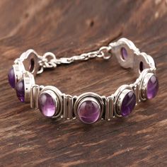 Oval amethyst poses in sterling settings like perfect plums. From Bhavesh this silver bracelet is a modern classic. .925 Sterling silver Round Amethyst Bracelets With Gemstone Accents, Nickel-free Amethyst Bracelet, Elegant Nickel Free Purple Bracelets, Elegant Nickel-free Purple Bracelets, Adjustable Sterling Silver Amethyst Gemstone Bracelet, Silver Amethyst Bangle Bracelet, Silver Amethyst Bangle Bracelets, Adjustable Silver Amethyst Bracelets, Adjustable Purple Gemstone Sterling Silver Bracelet