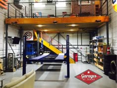 the inside of a large garage with stairs and storage racks on either side of it