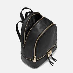 The ‘Rhea’ black leather backpack is an exquisite piece from MICHAEL Michael Kors. It's elegantly fashioned from grained leather and accentuated with delicate gold-tone hardware. Michael Kors Rucksack, Net Leggings, Coach Parker, Men's Totes, To Buy List, Medium Backpack, Black Leather Backpack, Buy List, Handbags Michael Kors