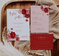 the wedding stationery is laid out on a wooden tray with furnishing and red flowers