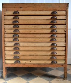 an old wooden drawer with metal knobs on it's sides in a room