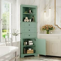 a bathroom with a sink, toilet and green cabinet in the corner by the bathtub