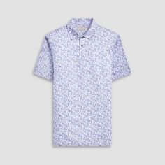 The Victor abstract print OoohCotton short-sleeved polo shirt featuring a three-button placket, mother-of-pearl buttons, and a self-fabric collar is the ideal choice for looking and feeling your best, whether you are enjoying a casual day or performing on the golf course. OoohCotton is a performance, double-mercerized, wrinkle-resistant, breathable, and easy-care cotton blend with 8-way stretch, quick-dry, and thermal comfort properties. White Buttoned Polo Shirt For Summer, Spring Short Sleeve Polo Shirt, Short Sleeve Polo Shirt For Summer Golf, Summer Short Sleeve Polo Shirt For Golf, Spring Short Sleeve Golf Polo Shirt, Spring Golf Polo Shirt With Short Sleeves, Spring Graphic Print Polo Shirt, Fitted Polo Shirt With Buttons For Spring, Spring Polo Collar Golf Tops