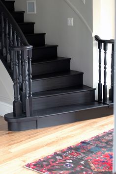 there is a rug on the floor in front of some stairs and handrails