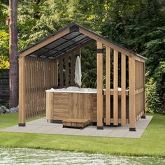 a wooden gazebo with a hot tub in it