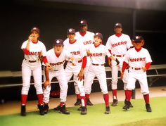 a group of baseball players standing next to each other