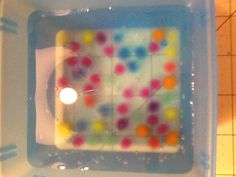 a plastic container with some colored dots in it