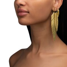 Accent your ear with our small 18K yellow gold Feather Drop Earrings. Measuring approximately 1.5 inches in length they're the perfect everyday earring for a bit of subtle flair or as an accent earring in your second or third piercing. For a funkier, head-turning look, we suggest wearing these small feather earrings in your second or third piercing paired with our Medium Feather Earrings. Dangly Gold Earrings, Third Piercing, Gold Feather Necklace, Gold Feather Earrings, Golden Earring, Double Heart Ring, Bold Women, Gold Feathers, Golden Earrings