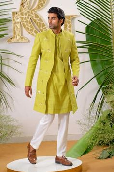 Fresh green full sleeve sherwani with gold filigree lotus applique embroidered motifs and embellished with cutpipe work. Paired with kurta and ivory pant pyjama.
Components: 3
Pattern: Embroidery, Embellished
Type Of Work: Cutpipe
Neckline: Mandarin collar
Sleeve Type: Full sleeves
Fabric: Sherwani: Cotton Linen, Kurta: Pure Cotton, Pant Pyjama: Vegan Silk
Color: Green
Other Details: 
Disclaimer: The fabrics used, are handwoven, hence may have impurities or slubs/variation in the weave that beau Lotus Applique, Green Sherwani, Linen Embroidery, Kurta Men, Embroidered Motifs, Nehru Jackets, Pattern Embroidery, Gold Filigree, Fresh Green