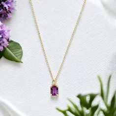 Find inner peace and tranquility with our stunning Violetta Amethyst Baguette Necklace. The vibrant purple amethyst crystal stone symbolizes harmony and calmness, making it the perfect addition to any outfit. Elevate your style and energy with this beautiful piece. 14K Gold filled materials Chain: 18” gold filled 1mm Rolo chain Pendant: 11.4mm x 5.2mm x 4.2mm Hypoallergenic and safe for those with allergies Handcrafted in the USA! Elegant Amethyst Pendant Jewelry, Artisan Gold Necklace With Amethyst, Elegant Polished Amethyst Necklace, Amethyst Necklaces For Gifts, Fine Jewelry Style, Inspirational Graphic Tees, High-end Faceted Amethyst Necklaces, Baguette Necklace, Find Inner Peace, Finding Inner Peace