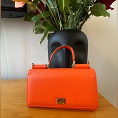 This Dolce & Gabbana Purse Is Like New And In Great Condition. This Purse Comes With A Leather Removable Strap And Original Box. Luxury Orange Satchel With Detachable Strap, Designer Orange Top Handle Satchel, Luxury Orange Shoulder Bag With Double Handle, Luxury Orange Crossbody Satchel, Classic Orange Evening Bag, Chic Orange Formal Satchel, Orange Evening Bag With Detachable Strap, Luxury Orange Bags With Top Carry Handle, Designer Orange Bags With Top Carry Handle