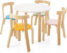 four children's wooden chairs around a white table