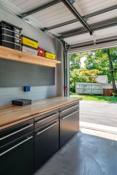 an open garage with lots of storage space and drawers on the counter top in front of it