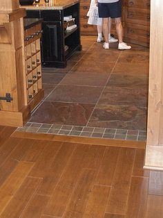 a woman standing in a kitchen next to an oven