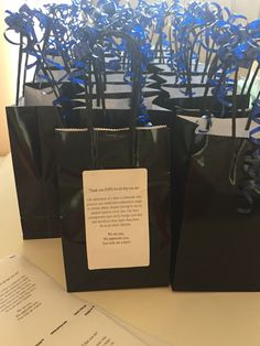 black bags with blue stems in them sitting on a table