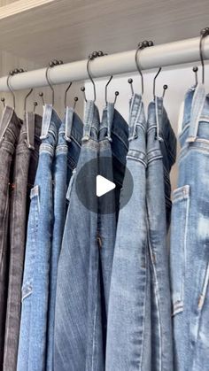 several pairs of jeans hanging on a rail