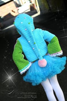 a stuffed animal wearing a blue and green outfit