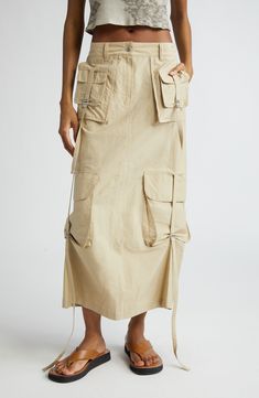 Utility-inspired impact defines this cotton-blend cargo skirt that's packed with pockets and cinched with buckled straps. 32 1/2" length (size 34EU) Zip fly with snap closure Front slant pockets; cargo flap-patch pockets; back zip pocket Adjustable buckle side tabs Back vent Unlined 85% cotton, 15% nylon Dry clean or hand wash, dry flat Made in Portugal Designer Clothing Buckle Skirt, Stockholm Street Style, Latest Skirts, Cargo Skirt, Black Midi Skirt, Denim Midi Skirt, Designer Clothes For Men, Gray Skirt, Shearling Jacket