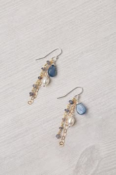 Experience the beauty and craftsmanship of the Seaside Collection with these gorgeous handmade earrings. Mixed Metal (lead and nickel free) Kyanite, Iolite, Pearl 2", with sterling silver ear wires We hand select our natural materials, thus there may be slight variations in color and/or size that will not detract from the overall aesthetic Our unique handcrafted designer jewelry for women is made in America, with each design created individually in our personal design studio in Floyd VA USA Cool Metal Jewelry, Wire Wrapped Bead Earrings Tutorial, Big Beaded Earrings, Beads Earrings Design, 2025 Earring Trends, Cute Homemade Jewelry, Earings Beads Ideas, Funky Beaded Earrings, Making Beaded Earrings