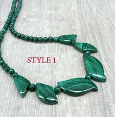 "Genuine Malachite gemstone beaded necklace, made of dark green stone beads in round and leaf shapes. Natural malachite jewelry, dainty bib necklace. Length: from 18 and 19 \" ( 46 and 48 cm ) - can be shortened on request. Beads: 4 mm balls and leaves measuring from 15 to 30 mm long. Please see all photos and select the style: Style 1 - the necklace with wider spread leaves, 19 inches long. Style 2 - the necklace with darker leaves placed closer together and making more V-shape, 18 inches long. Adjustable Green Malachite Jewelry, Green Malachite Gemstone Bead Jewelry, Green Malachite Jewelry With Gemstone Beads, Malachite Gemstone Bead Necklaces, Malachite Gemstone Beads Necklace, Adjustable Malachite Gemstone Beads Jewelry, Malachite Gemstone Necklaces With Round Beads, Malachite Gemstone Round Beads Necklace, Green Gemstone Necklaces With Round Beads