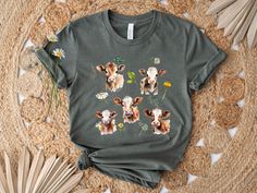 Looking for the perfect farmcore or cottagecore gift for a farmer or animal lover? Our cow t-shirt features beautiful cows and flowers. The cow shirt is made of soft fabric with a crew neck. It is the ultimate gift for anyone who loves these beautiful creatures! ⭐Care Instructions ⭐ -Machine wash cold, inside-out, gentle cycle with mild detergent and similar colours. Use non-chlorine bleach, only when necessary. No fabric softeners. -Tumble dry low, or hang-dry for longest life. -Cool iron inside-out if necessary. Do not iron decoration. Do not dry clean. ⭐Note to Buyer⭐ In an effort to reduce waste, our items are sent out in a mailer bag, without additional labels or packaging. Thank you for standing with us against unnecessary waste ❤️ ⭐Ordering⭐ Please ensure that you use the size chart Casual Cow Print T-shirt For Summer, Cute Cotton T-shirt With Cow Print, Short Sleeve Cotton Tops With Cow Print, Cute Cow Print Cotton T-shirt, Cute Short Sleeve Cow Print T-shirt, Cute Cow Print Short Sleeve T-shirt, Casual Cotton T-shirt With Cow Print, Spring Cow Print Cotton Top, Cotton Cow Print Short Sleeve T-shirt