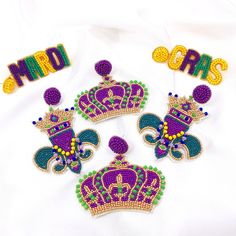 -Mardi Gras Seed Bead Earrings Size Mardi Gras Letter Dangle L: 2.46" W: 0.78" Crown L: 2.36" W: 2.56" Fleur De Lis L: 3.15" W: 2.16" Style Options [Letter] [Crown] [Fleur De Lis] Mardi Gras Beaded Earrings, Purple Dangling Beads Party Earrings, Purple Dangling Beads Earrings For Party, Purple Earrings With Colorful Beads For Crafting, Purple Beaded Jewelry For Mardi Gras, Purple Jewelry For Mardi Gras, Handmade Purple Earrings For Celebration, Purple Beaded Earrings For Party, Colorful Beads Jewelry For Mardi Gras Party