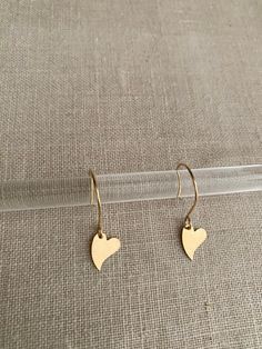 "Round hoop like ear wire with a gorgeous heart drop. Measure 1 ⅜\" All made of worry free 14Kt Goldfilled materials made in USA 🇺🇸  Will not irritate sensitive piercing  Will not change color or rub off" Heart-shaped Yellow Gold Hoop Earrings For Everyday, Everyday Heart-shaped Hoop Earrings In Yellow Gold, Yellow Gold Heart Hoop Earrings For Everyday, Minimalist Dangle Heart Earrings, Everyday Heart-shaped Yellow Gold Hoop Earrings, Dainty Dangle Heart Earrings For Everyday, Minimalist Gold Heart Earrings With Charm, Everyday Heart Hoop Earrings With Heart Charm, Everyday Heart Charm Hoop Earrings