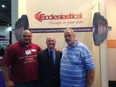 three men standing next to each other in front of a sign that says eddesastia