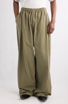 Balenciaga's outsized aesthetic informs the roomy proportions of relaxed pull-on pants fashioned from linden-colored cotton-canvas. Elastic waist Front slant pockets 100% cotton Dry clean Made in Italy Designer Clothing Logo Pants, Canvas Pants, Balenciaga Logo, Baggy Pant, Sand Beige, Free Fabric, Pull On Pants, Cotton Pants, Straight Pants