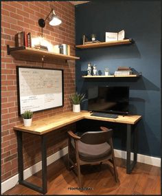 a home office with brick walls and shelves on the wall, along with a computer desk